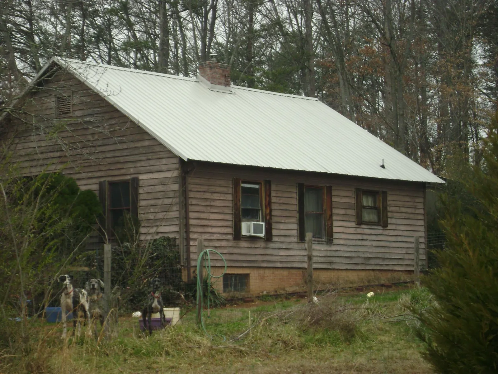 White metal roof on an old wood sided farmhouse, from a Metal Roof Installation job in Vassar